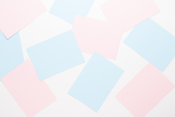 Abstract geometric background in light pastel tones from sheets of thick pale past paper.