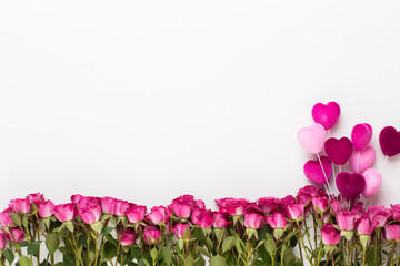 Flowers composition. Frame made of red rose on white wooden background. Flat lay, top view, copy space.
