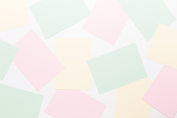 Abstract geometric background in light pastel tones from sheets of thick pale past paper.