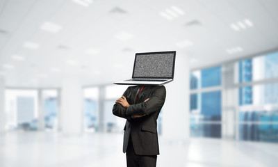 Businessman with laptop instead of head.