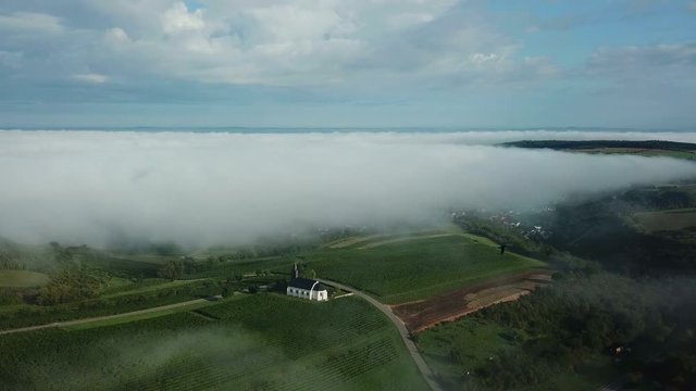 Aerial view of St. Rochus Chapel in the vineyards near Nittel with fog, Obermosel, Moselle Valley, Rhineland-Palatinate, Germany