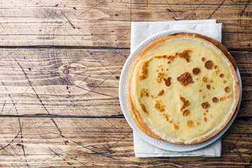 Thin pancakes on a plate. Wooden background. Copy space