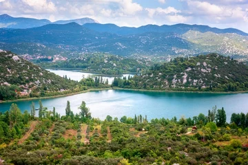 Foto op Canvas Amazing nature, scenic summer landscape with emerald lakes, mountains and blue cloudy sky, Bacina Lakes (Bacinska jezera), Croatia. Outdoor travel background, view from Adriatic highway © larauhryn