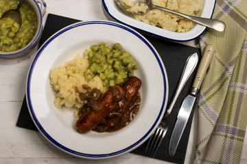  mashed potato, onion gravey, grilled sausages and mushy peas