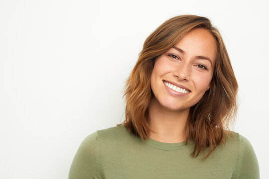 Portrait Of A Young Happy Woman Smiling On White Background