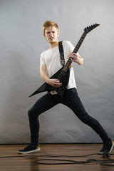 Fototapeta premium Man playing on electric guitar