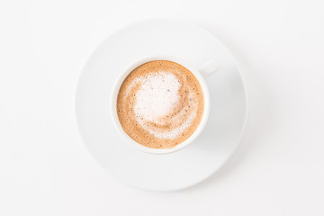 Coffee art. Latte cup on white background. Minimal flat lay.