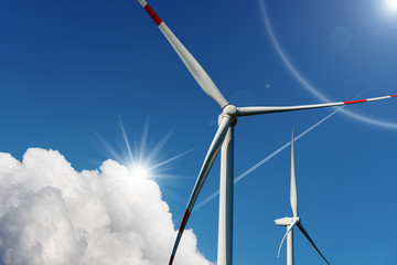 Two Wind turbines on blue sky - Renewable energy
