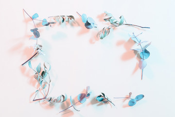 Creative dried foliage layout. Inverted colors design. Blue stems frame on ivory background.