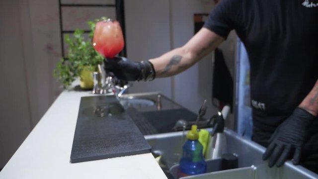 Barman serving freshly negroni cocktail at the counter. slow motion