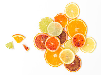 many fresh orange slices, lemon slices, lime slices, kumquat slices are nicely arranged on a white background