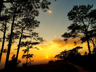 Silhouette sunset with mountain on winter,Travel take photo on mountain