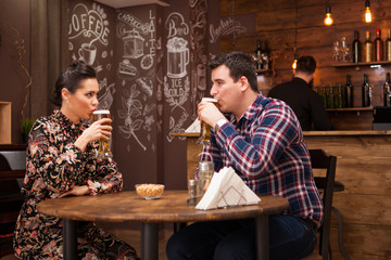 Couple in love on date drinking beer and having a good time. Beautiful couple.