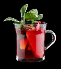 Hot drink with ginger and orange on black background