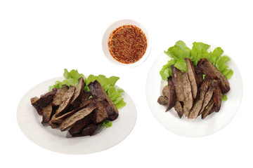 Grilled pork liver in a white dish and spicy flavor, isolated on white background with clipping path. Traditional Asian Food.