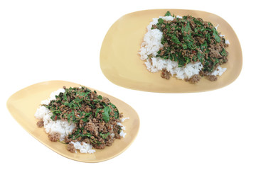Fried rice with basil in a plastic Yellow plate isolated on white background with clipping path. Concept Spicy foods that should not be used in certain types of containers.