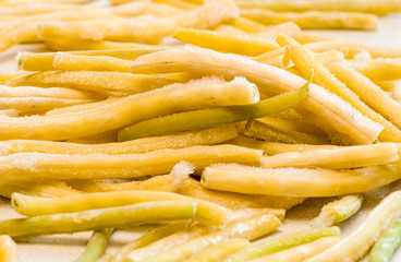 Frozen vegetables:  french beans. Frozen cut  beans vegetable. The concept of vegetarianism, background.