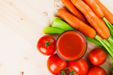 Glass of different vegetable juices with carrots, tomatoes and c