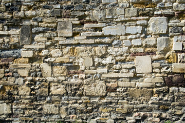 Old neglected stone wall full frame background texture