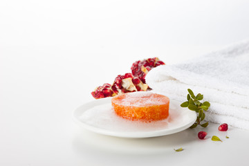 Natural handmade soap on a white background. Pomegranate-scented skin care. Spa treatments and aromatherapy for smooth and healthy skin.