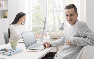 Obraz premium Confident male student posing and smiling