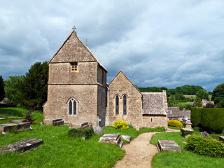 Fototapeta na wymiar Picturesque old church in Duntisbourne Abbotts, an idyllic Cotswold village, Gloucestershire, UK