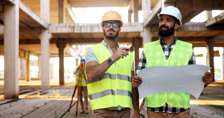 Portrait of construction engineers working on building site