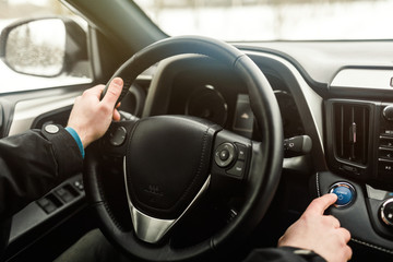 Car driver starting the engine.