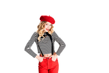 pretty woman in red beret and holding hands in pockets isolated on white