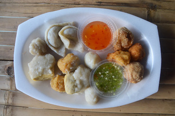 Mixed fish dumplings, fish ball on dish with sauce