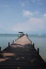 Wooden pier with ferry in harbor of Koh Samui island, Thailand