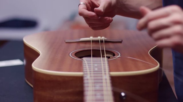 Man changes guitar strings