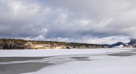 Lake. Frozen. Winter. Ice. Snow. Forest. Hills