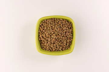 Yellow lentil in a bowl isolated on white background