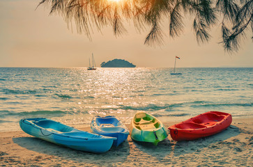 Plastic boats on sandy beach