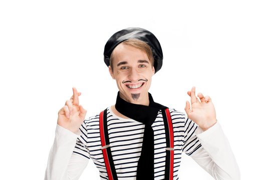 Smiling French Man In Black Scarf And Beret Holding Fingers Crossed Isolated On White