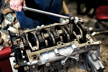 Automotive four-cylinder engine water cooling during repair.