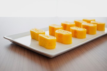 Tamagoyaki. Japanese rolled omelet on white plate.
