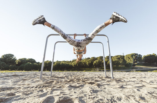 Woman training on parallel bars