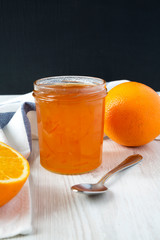 Obraz na płótnie Canvas Homemade orange marmelade in glass jar, side view. Closeup.