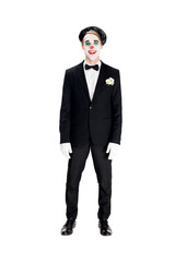 cheerful clown in black beret and suit smiling isolated on white