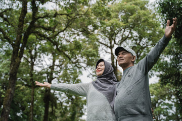 senior couple close their eyes and enjoying nature