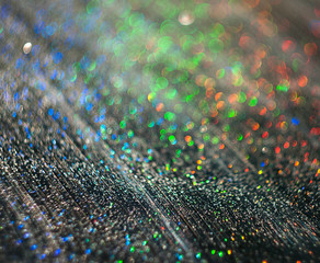 The unfocused background of the silver glitter of water droplets on the black for text, banner,...