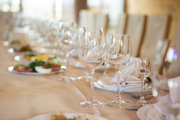Wedding table decorated with flowers. Table setting for a banquet before the meal. Beautiful table setting on a holiday.