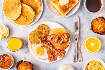 Healthy Full American Breakfast with Eggs Bacon Pancakes and Latkes.