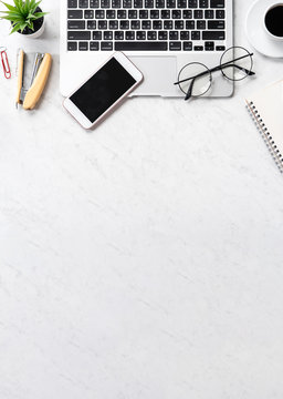 Stylized marble office working desk with smartphone, laptop, glasses and coffee, workspace design, mock up, topview, flatlay, copyspace, closeup