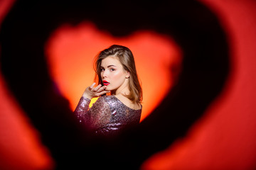 Happy valentines day. Valentines day attribute. Prepare celebration valentines day. Girl makeup and shimmering dress. Love and romance. View through heart shape silhouette woman pretty fashion model