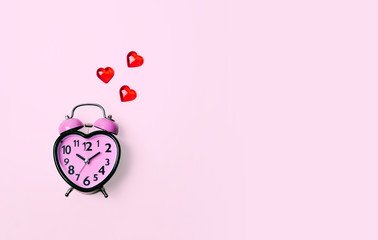 Heart shaped clock on pink background.