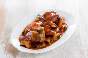 fish with seafood and sweet potato on white dish