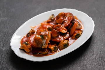 fish with seafood and sweet potato on white dish